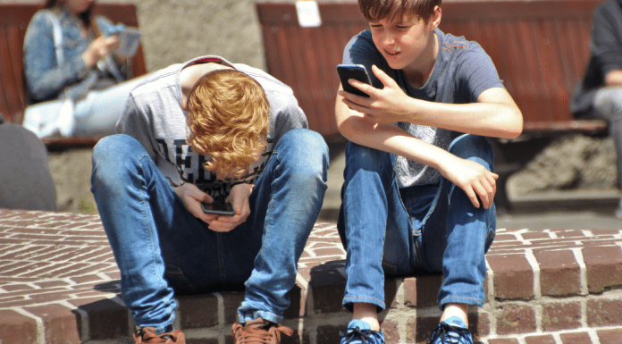 Two boys on their phone.