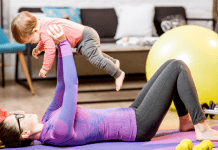 A woman working out with a baby.