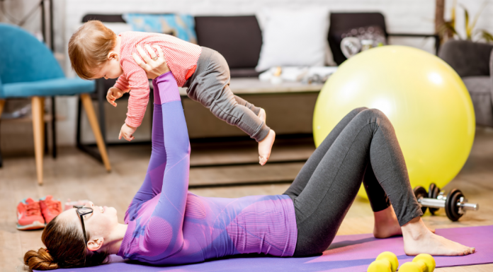 A woman working out with a baby.