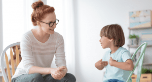 Woman speaking with a young boy.