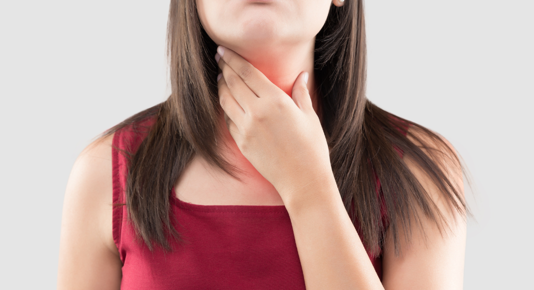 A woman feeling her thyroid.
