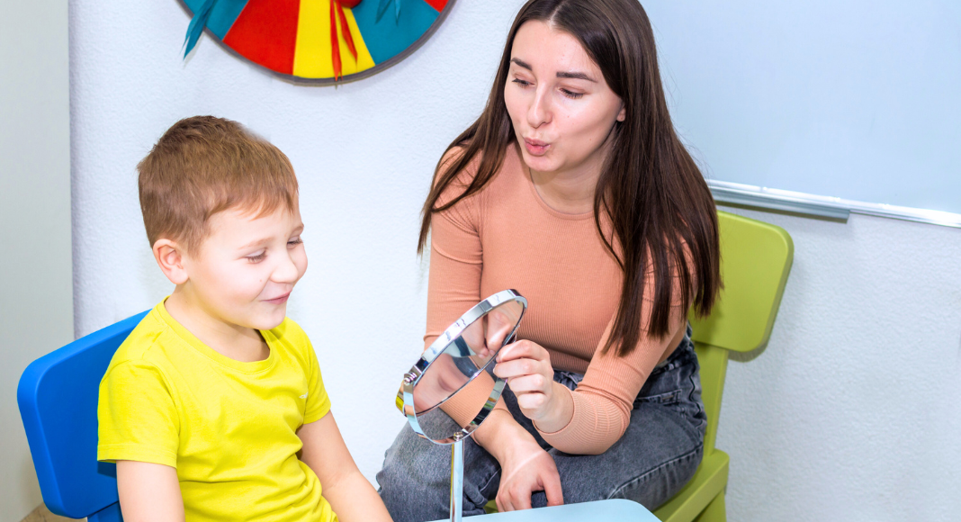 A speech pathologist working with a child.
