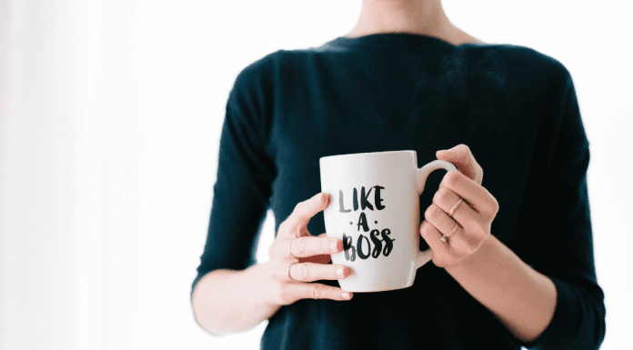 A woman holding a mug that says "Like a Boss."