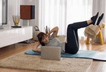 A woman doing an at-home workout in her living room.