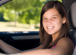A teen driving a car.
