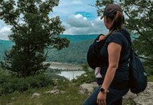 A mom hiking with a baby carrier.
