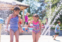 Girls playing in a local splash pad.