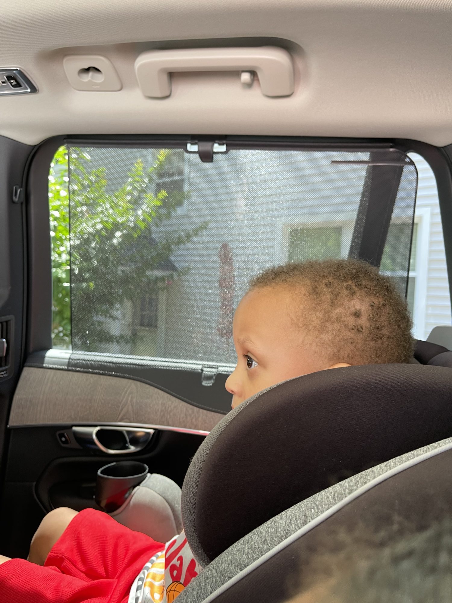 A little boy sitting in a car seat in an XC90.