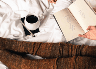 Resting in bed with a book and coffee.