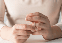 A woman removing her wedding ring.