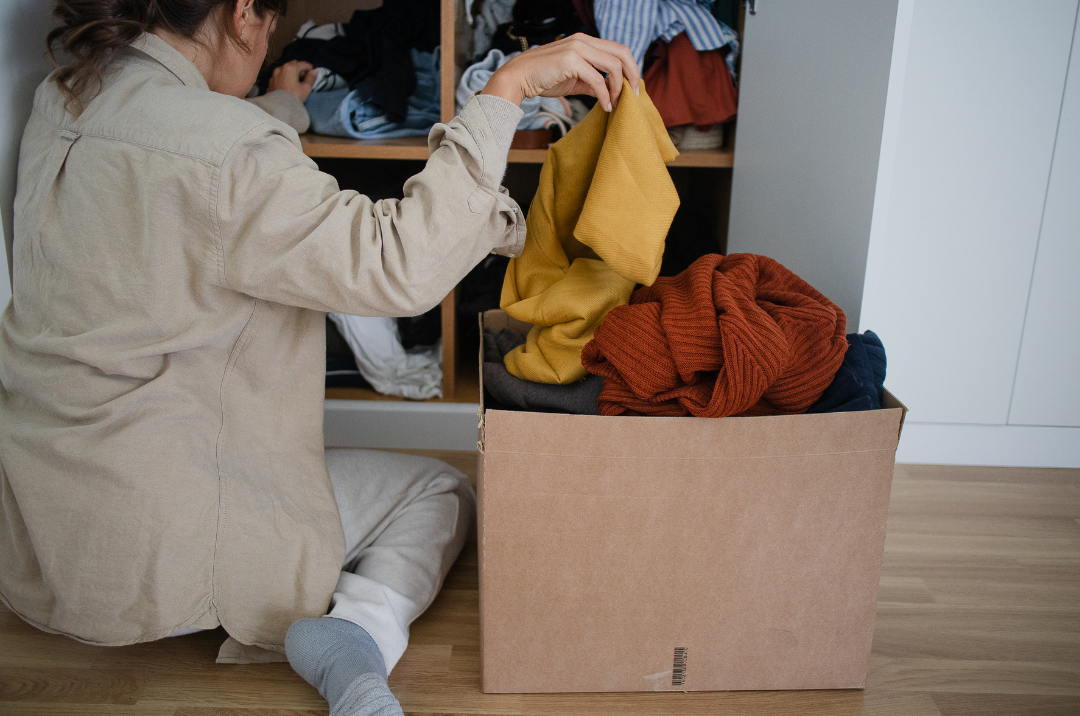A woman organizing her wardrobe.
